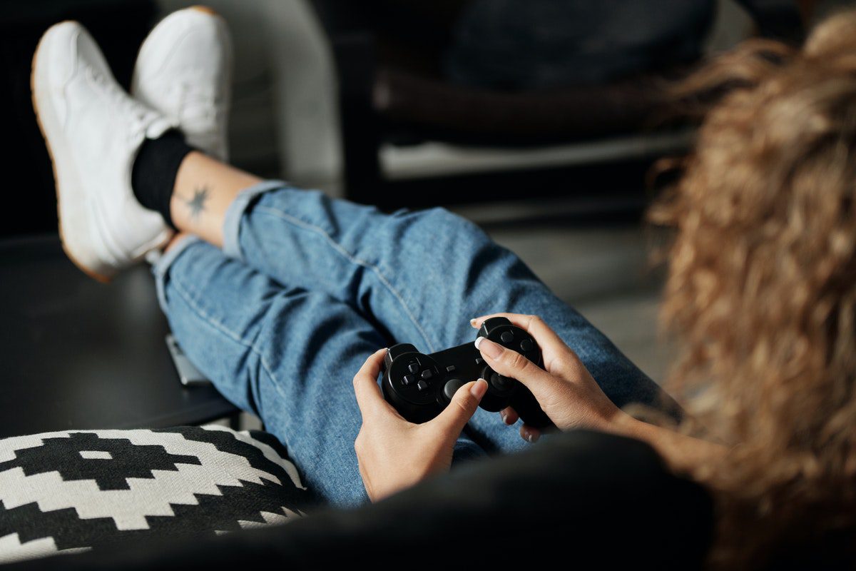 A man seated while playing video games. Who Uses Lua?