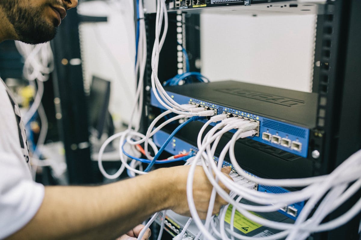 A systems administrator checking wire connections to a server Entry Level Systems Administrator Jobs