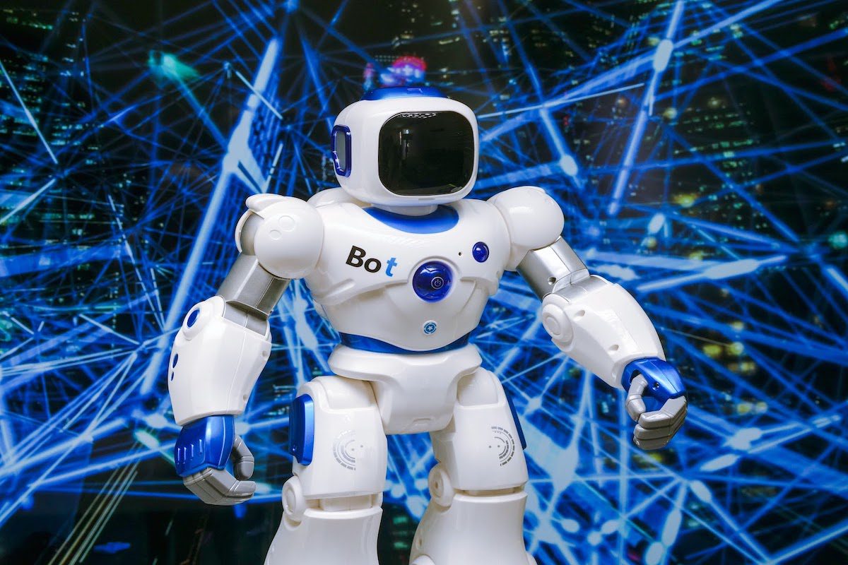 A white robot in front of an array of blue lights Top New Trends in AI for the Future