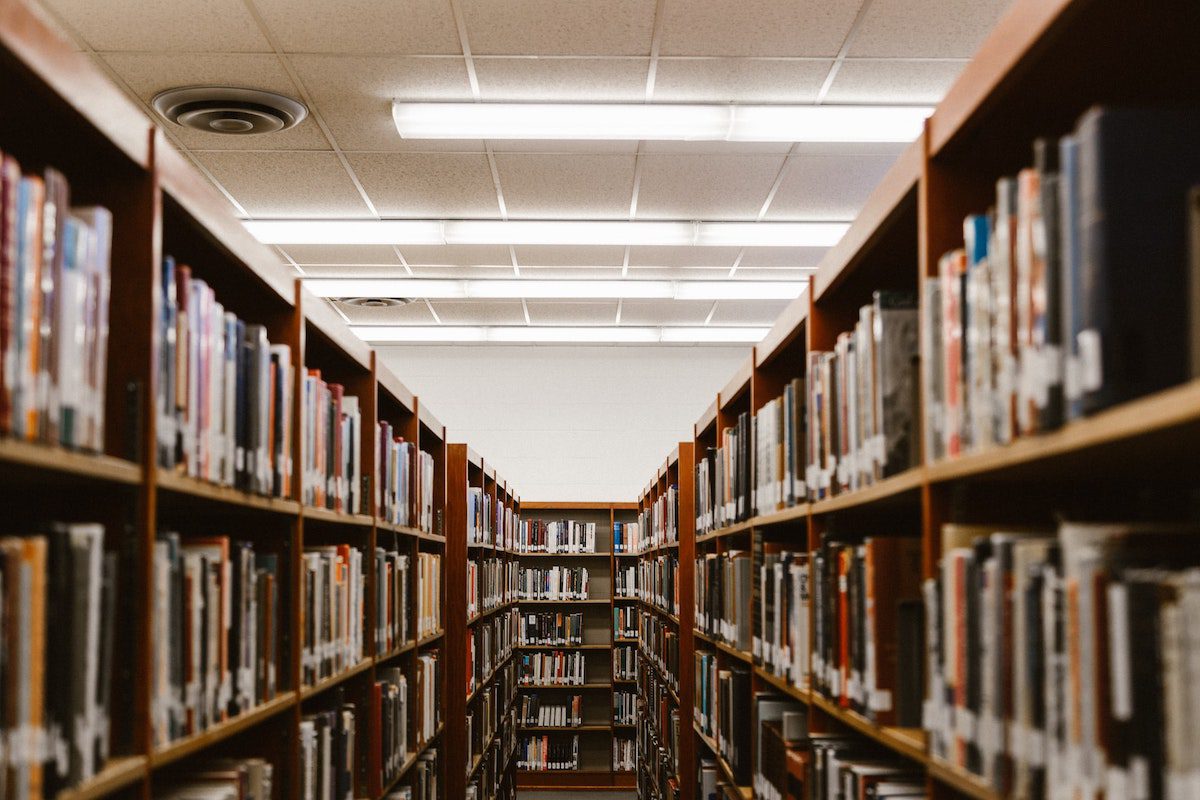 Shelves of books in a library row. Best Universities In North Carolina