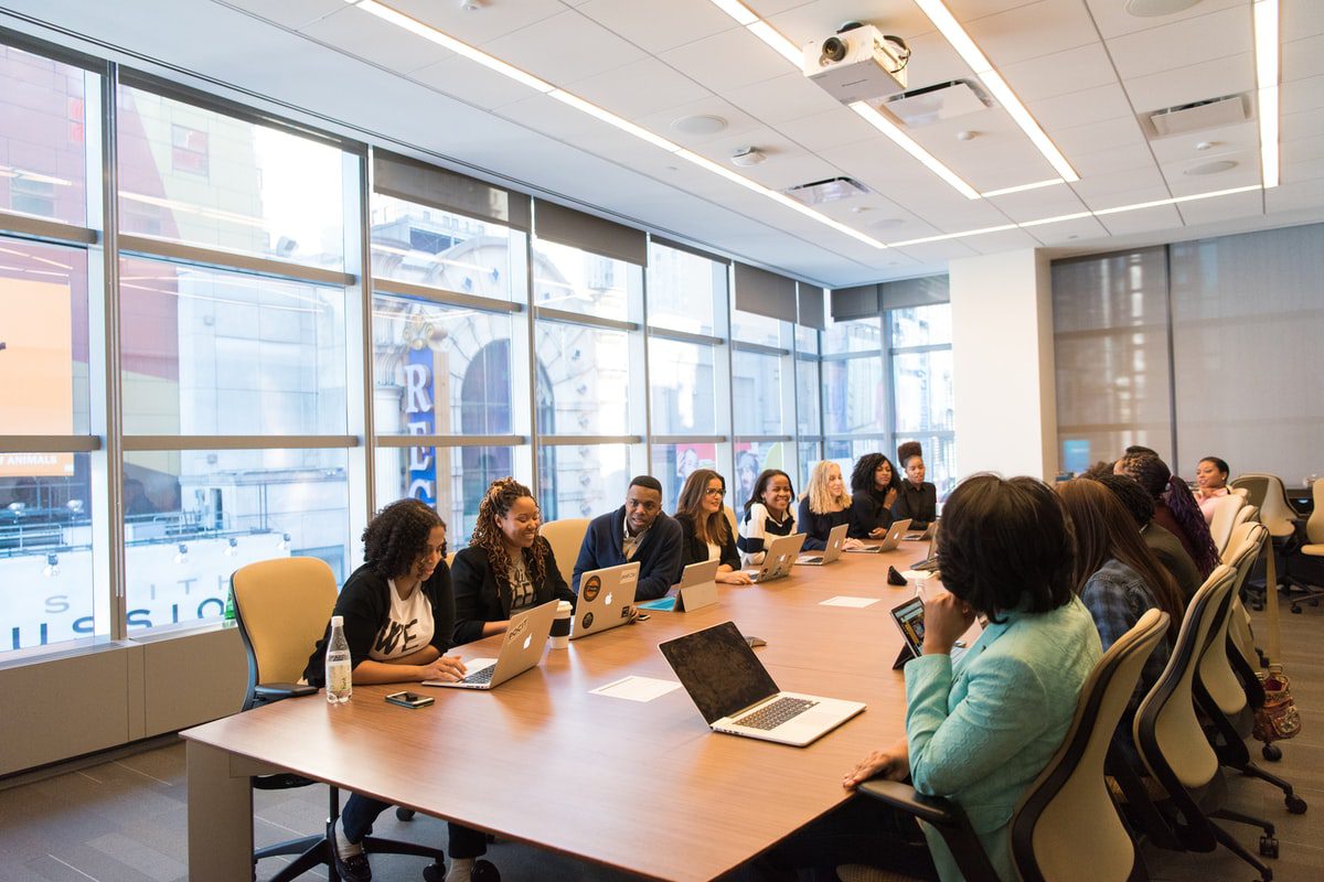 Employees gathered for a meeting in a boardroom