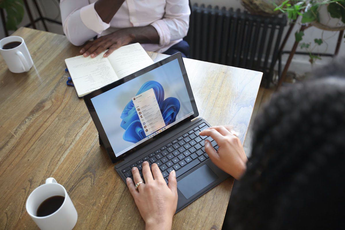 Two professionals meeting to discuss the use of archive folders in Outlook. How to Create An Archive Folder In Outlook 