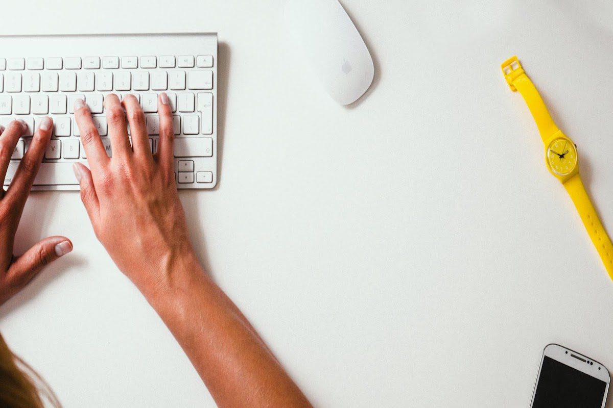 Hands typing on a keyboard.