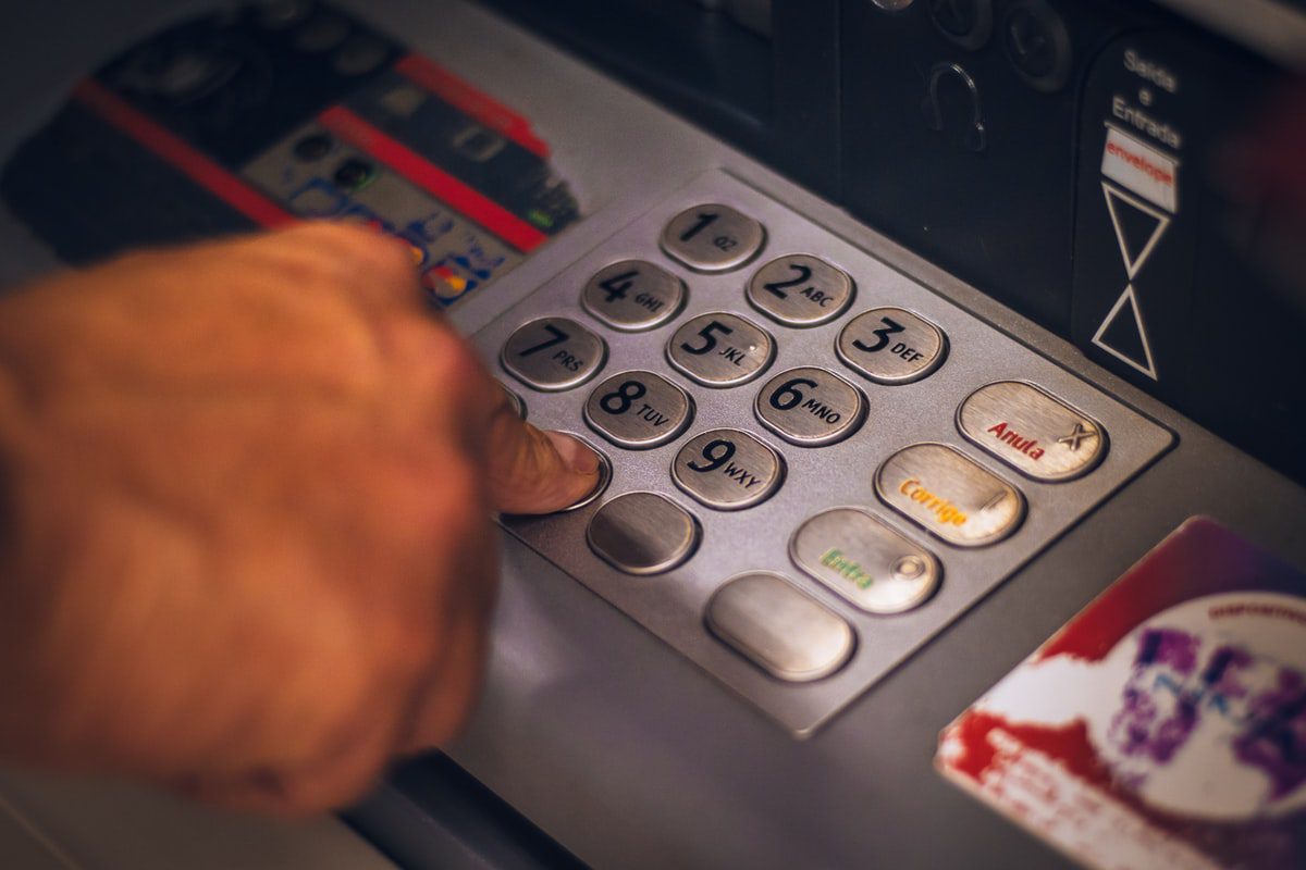 A person entering card information using an ATM.