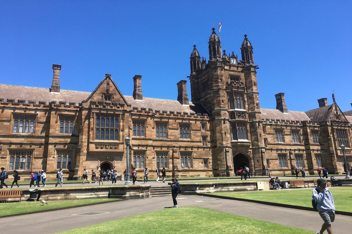 Students walking around a historic university campus.