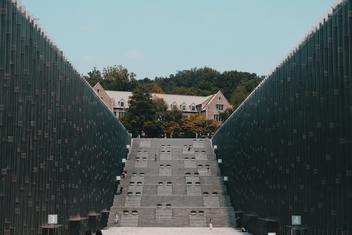 A zoomed out view of Ewha Womans University in South Korea, showing long concrete steps leading up to a campus building