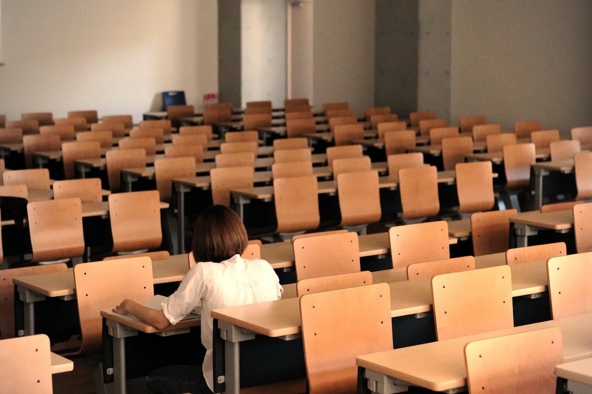 A student sitting down in an auditorium getting ready for her intensive studies Best Universities In Japan
