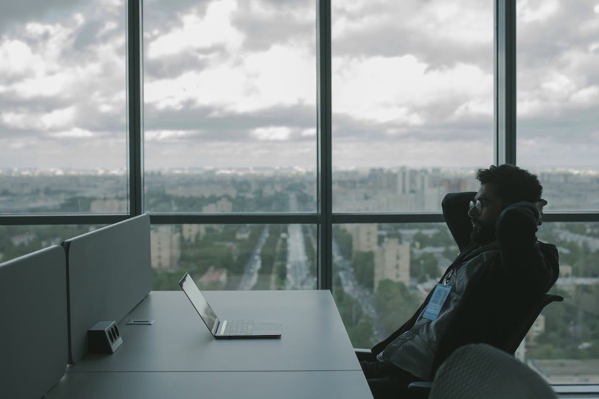 Man sitting at a desk with his laptop at work  Career Counseling for High School Students