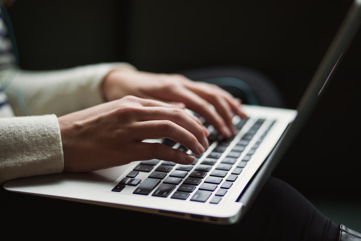 A person typing on a  laptop