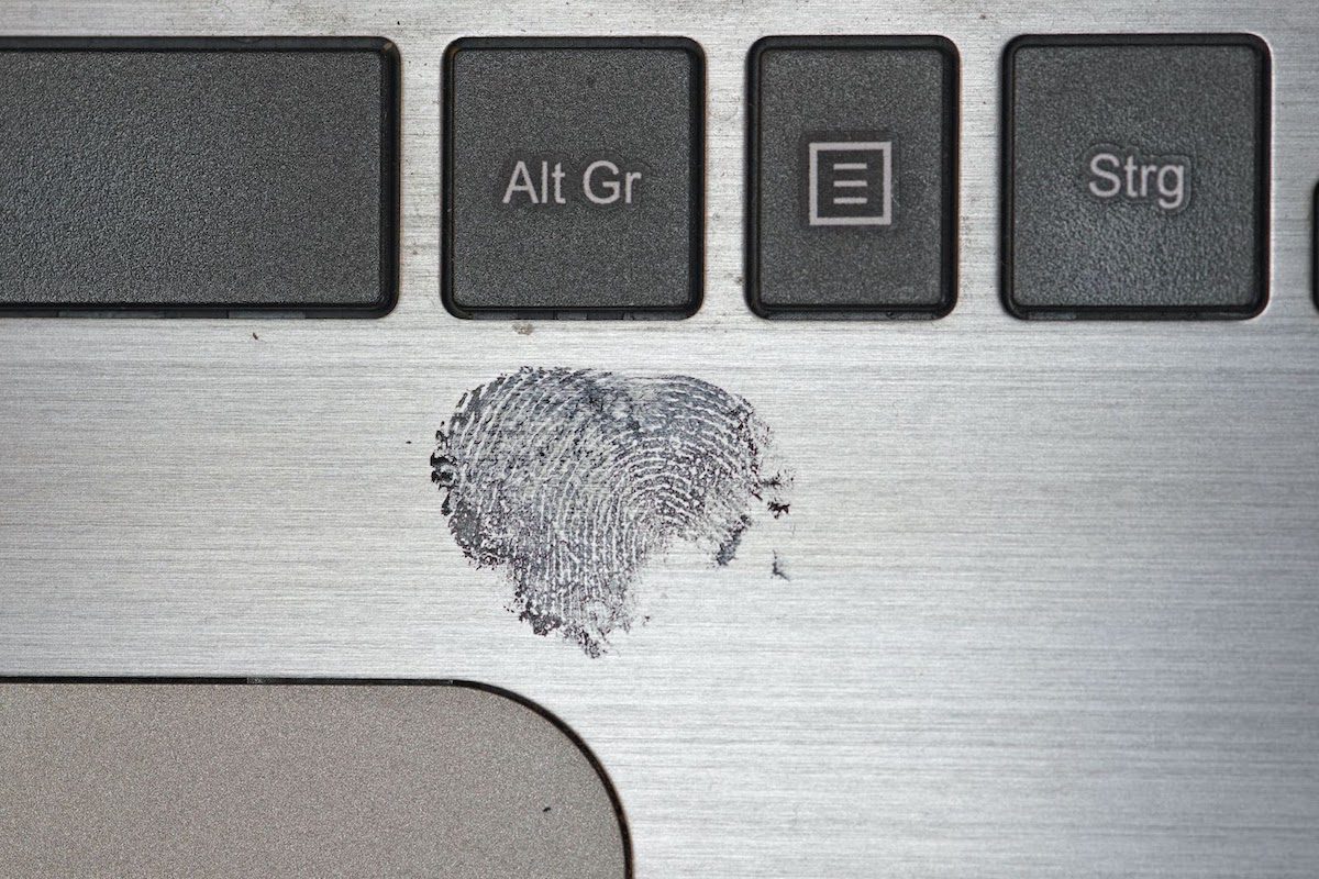 A closeup image of a fingerprint on laptop keyboard