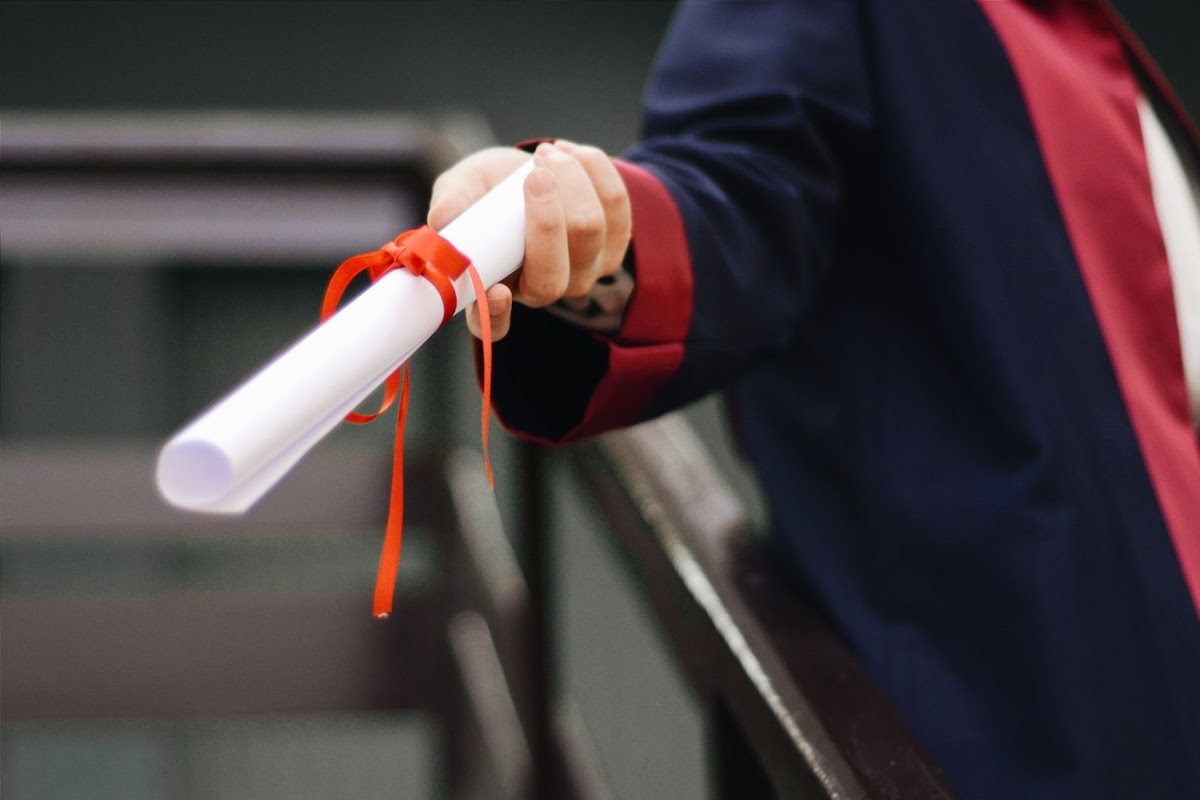 graduate holding a scroll
