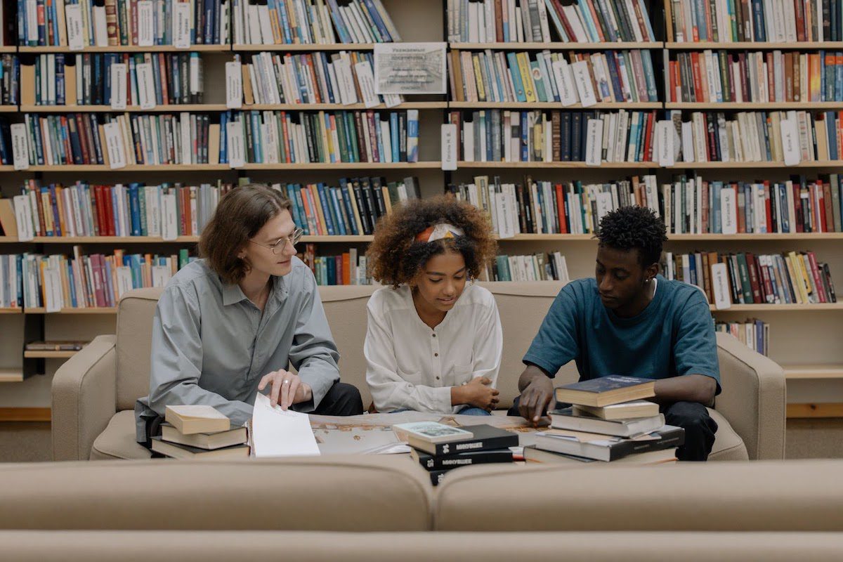  Three students studying together in a college library Best Online Library Science Bachelor's Degrees 
