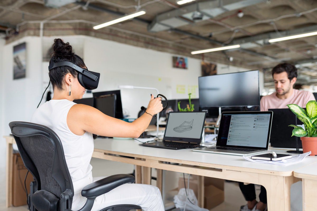 A person wearing a virtual reality headset while designing in-game features. Online Game Development Bachelor's Degrees