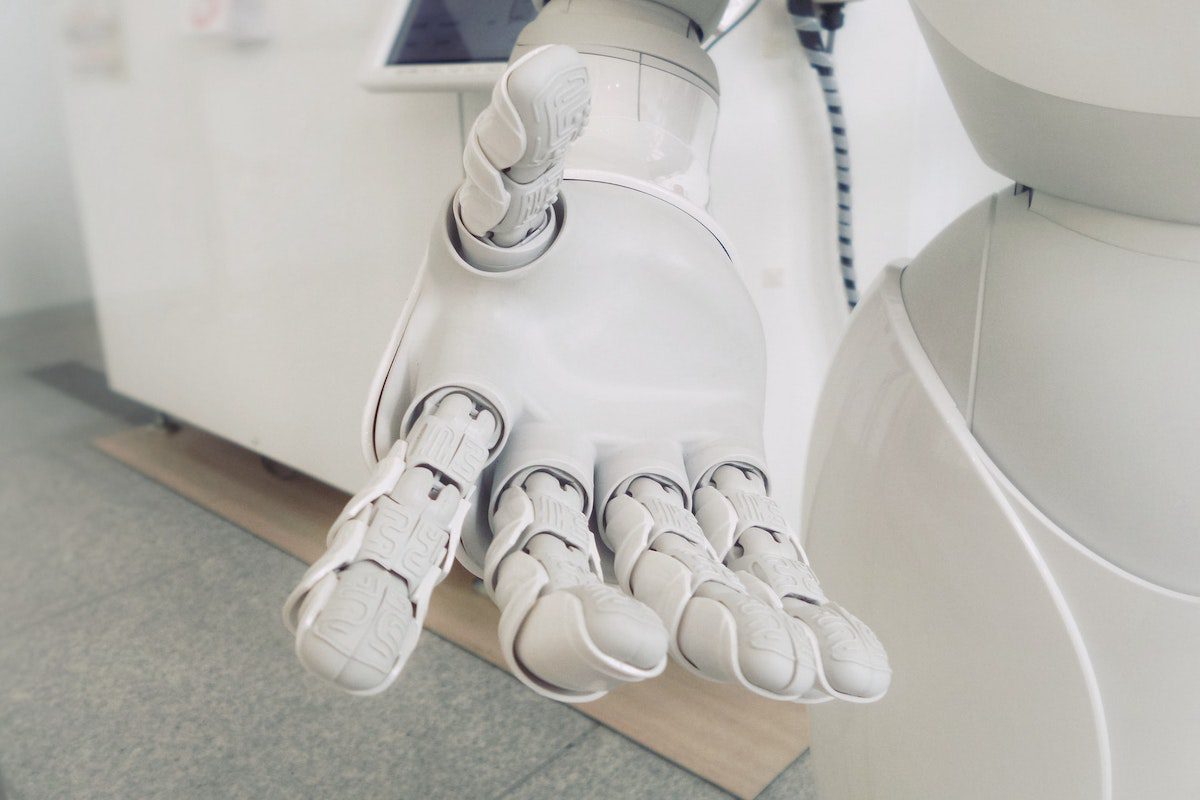 A close-up of a white robot hand showing details of its humanlike hand