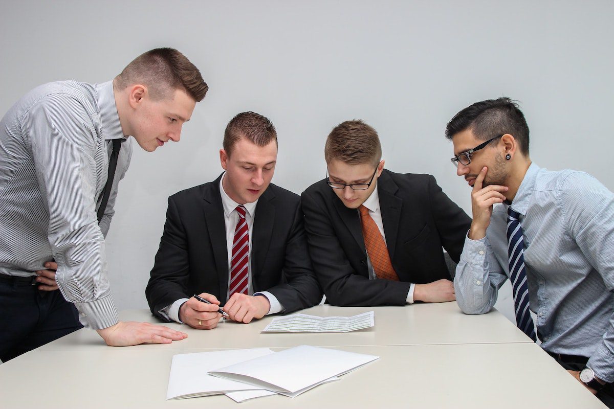 Four team members collaborating to decide how to bring groceries to customers more efficiently.  How to Get a Job at Instacart