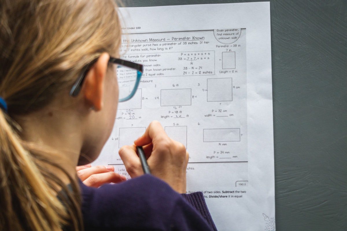 a female PhD Student solving a mathematical test