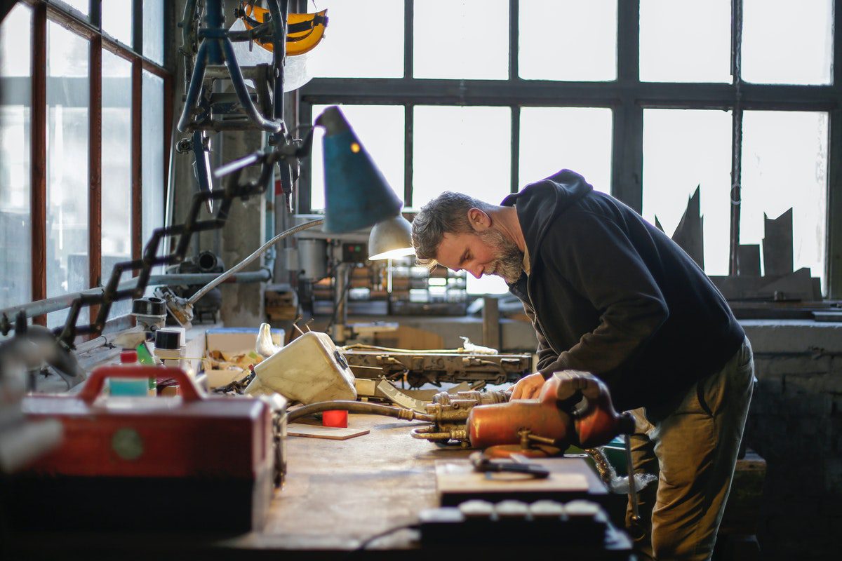 a man fixing mechanical components.