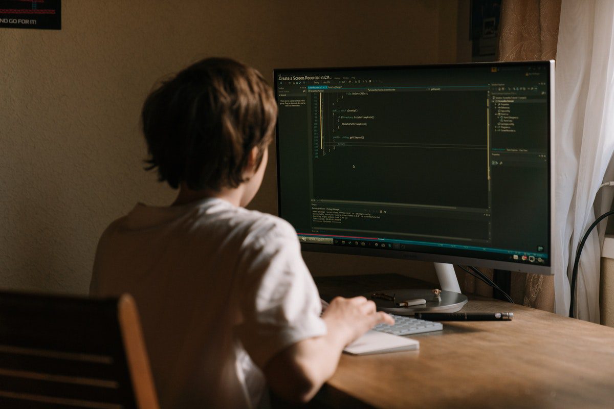 A person using a computer to write codes