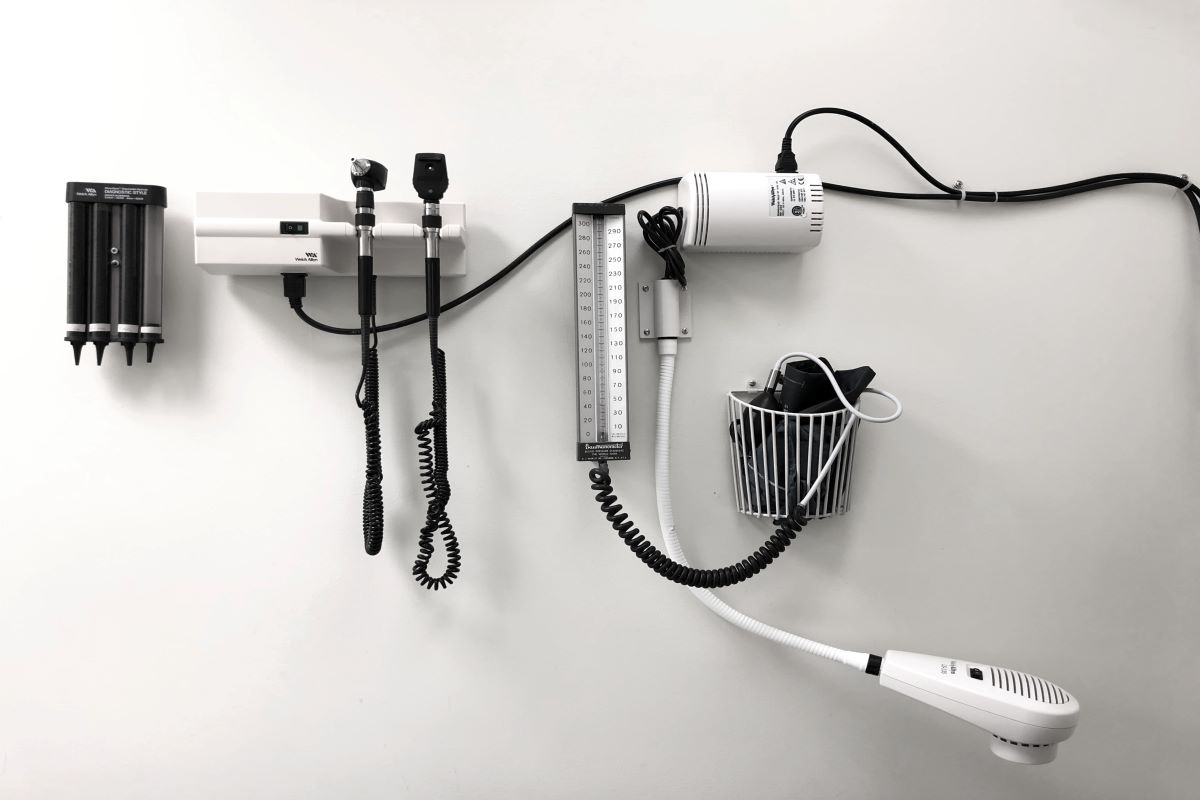 A black and white image of a wall with medical equipment on it.