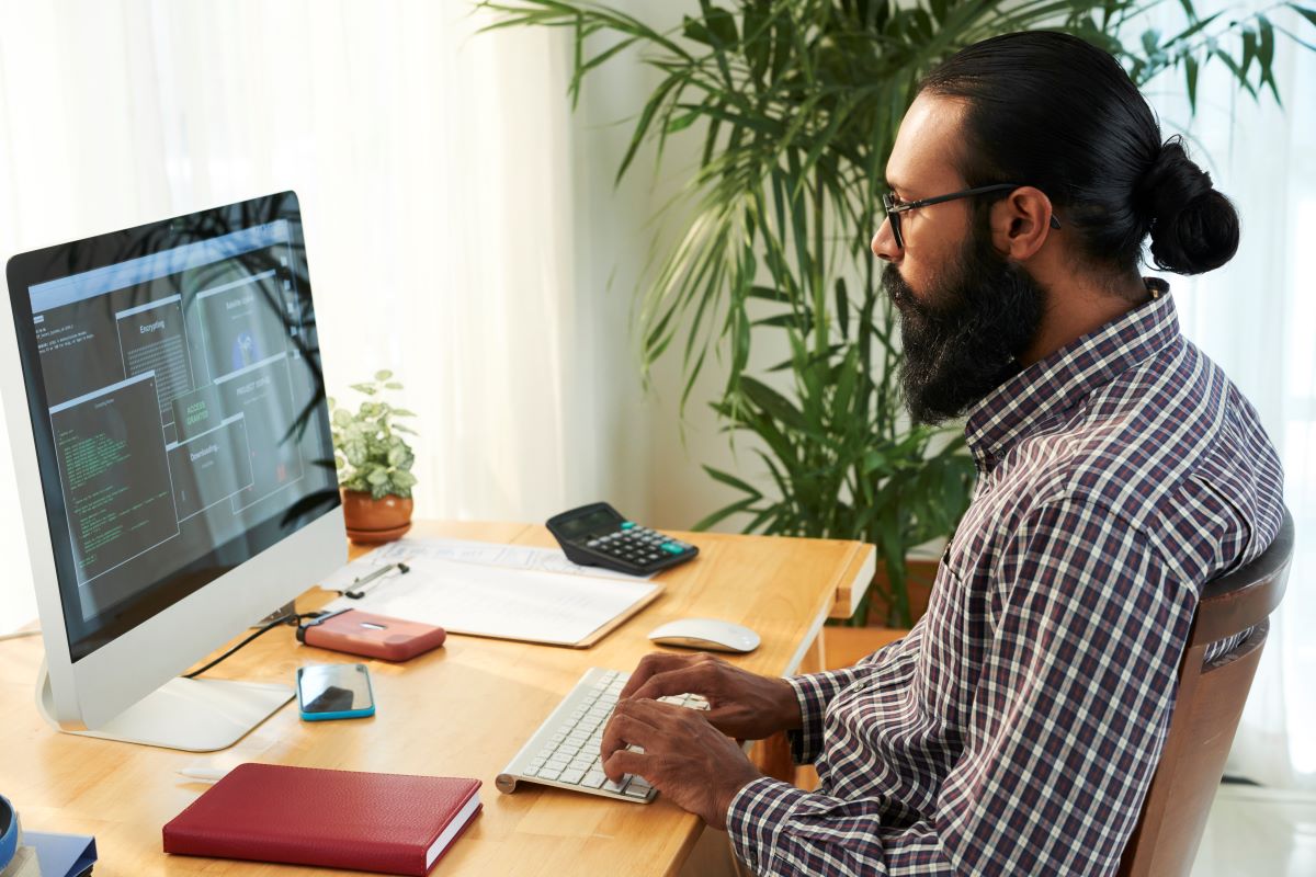 A web developer working at a desktop computer.