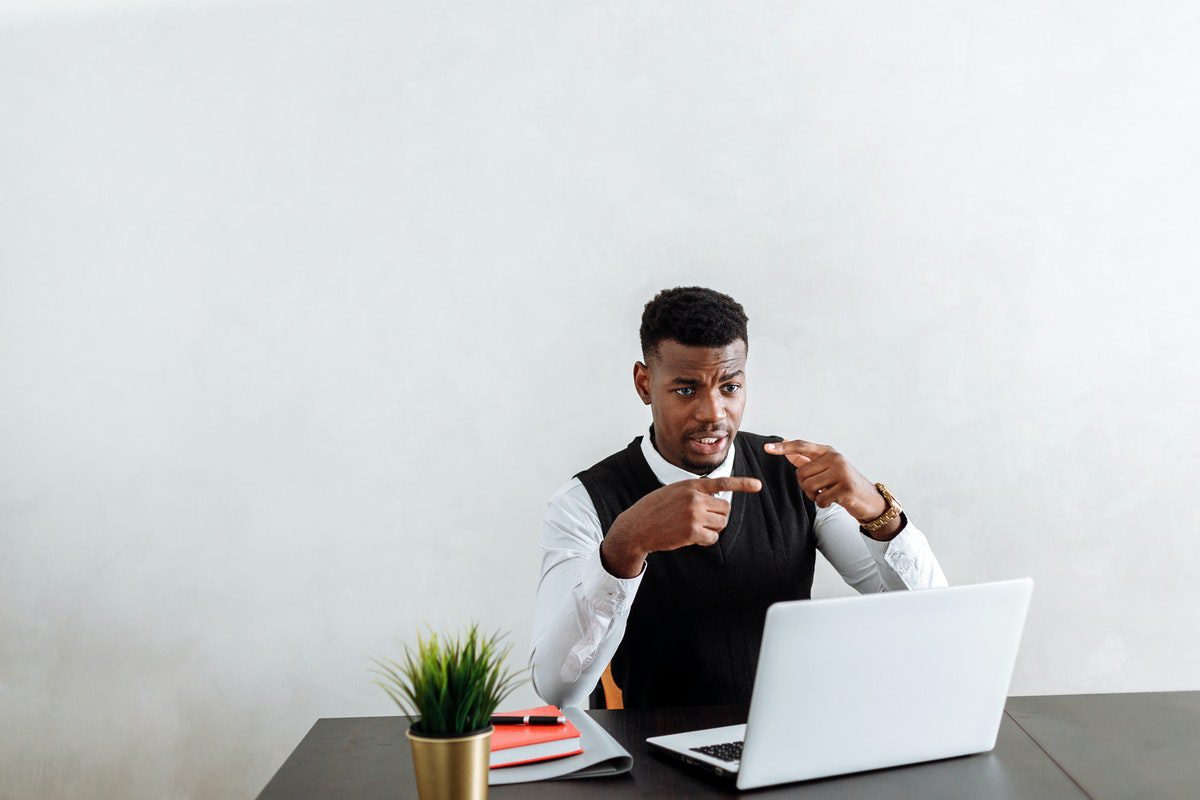 An investment banker in an online meeting with one of their clients