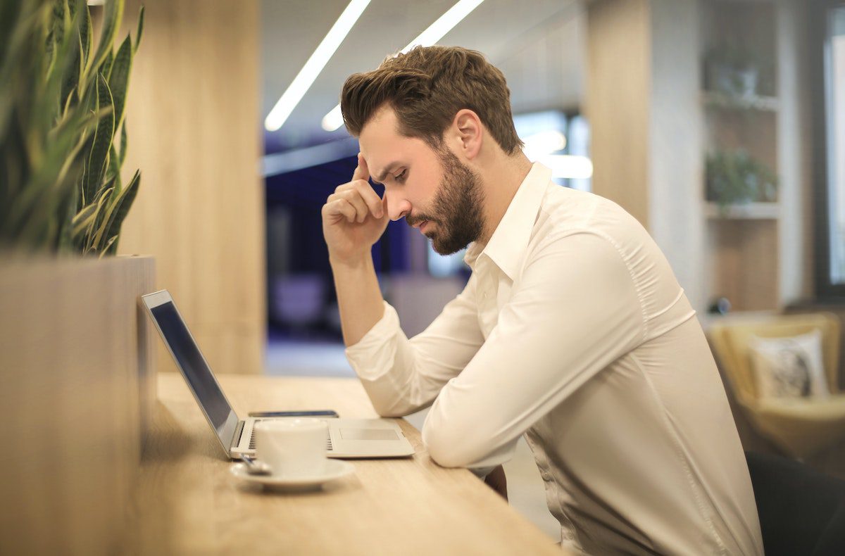 A man in front of a laptop using his problem solving skills