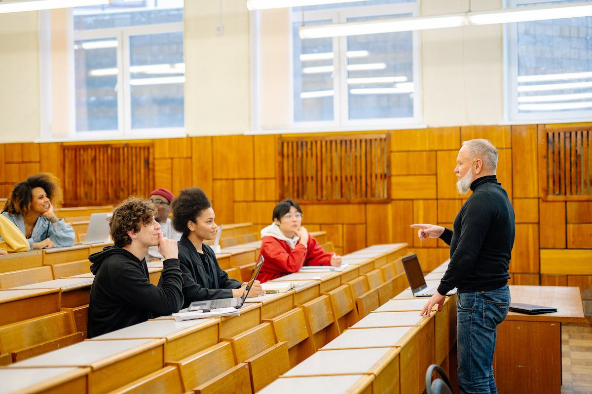 A classroom instructor teaching critical thinking to his current students.