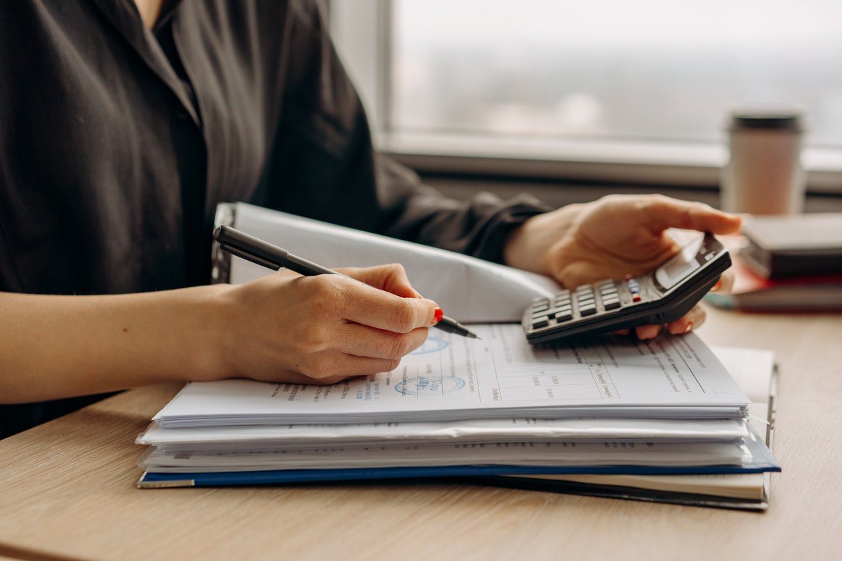 A student working with a calculator and a pad of paper.