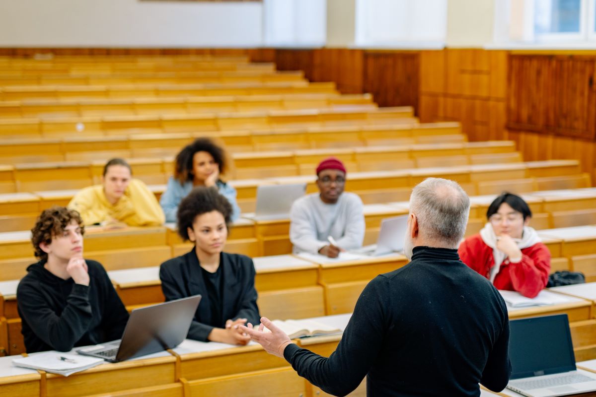 Full-time students enrolled at the university, attending a lecture in a lecture hall.