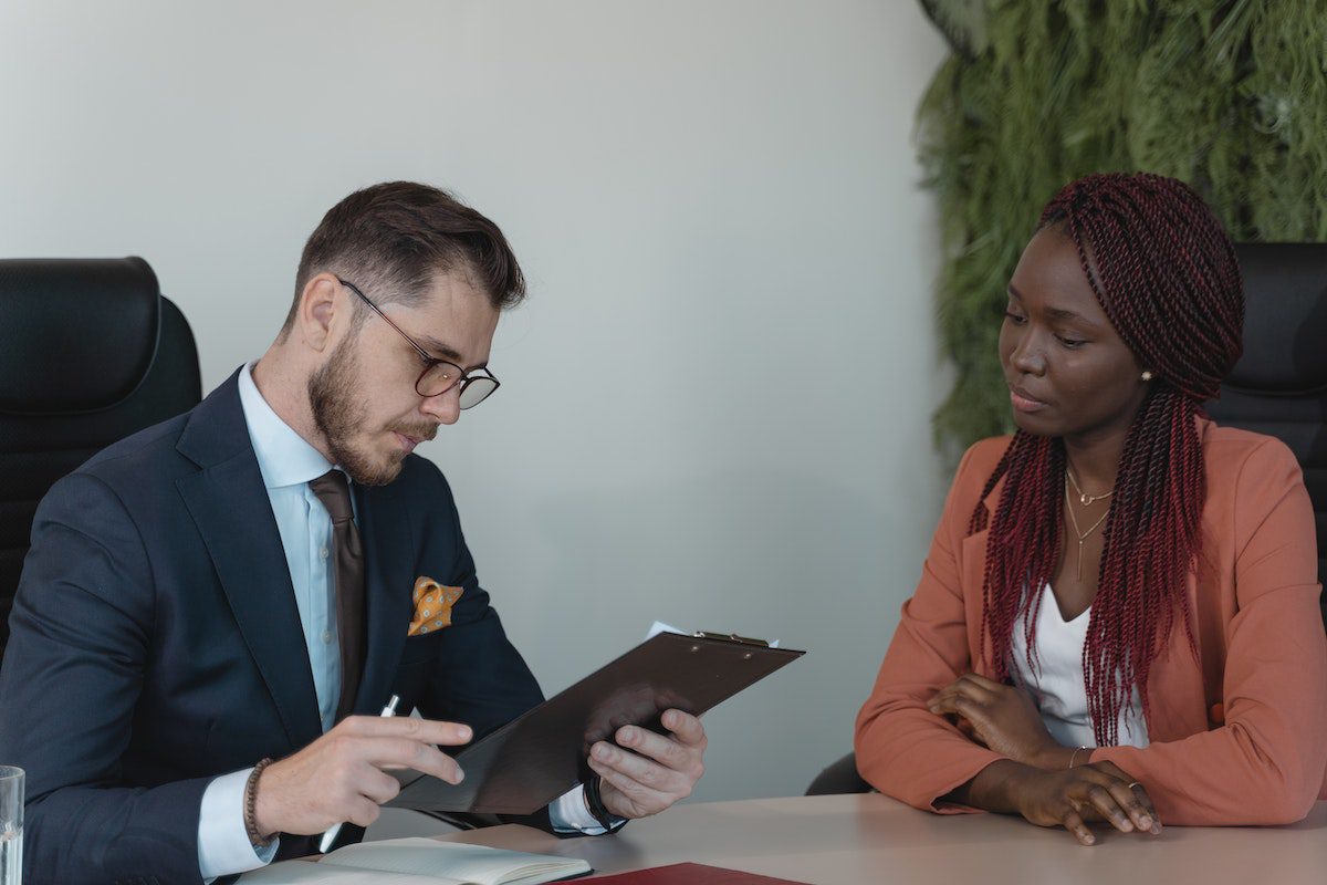 A manager reviewing a candidate’s resume in a job interview format