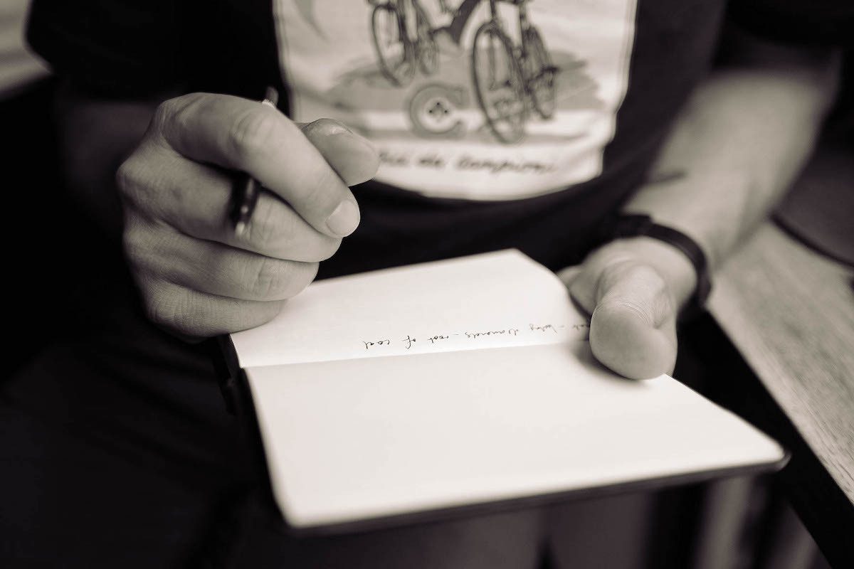 A person writing in a notebook