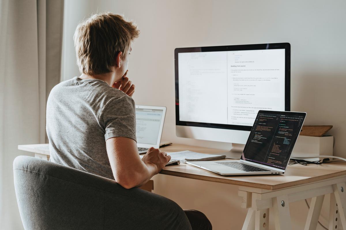 A man learning how to code on his own on a computer.