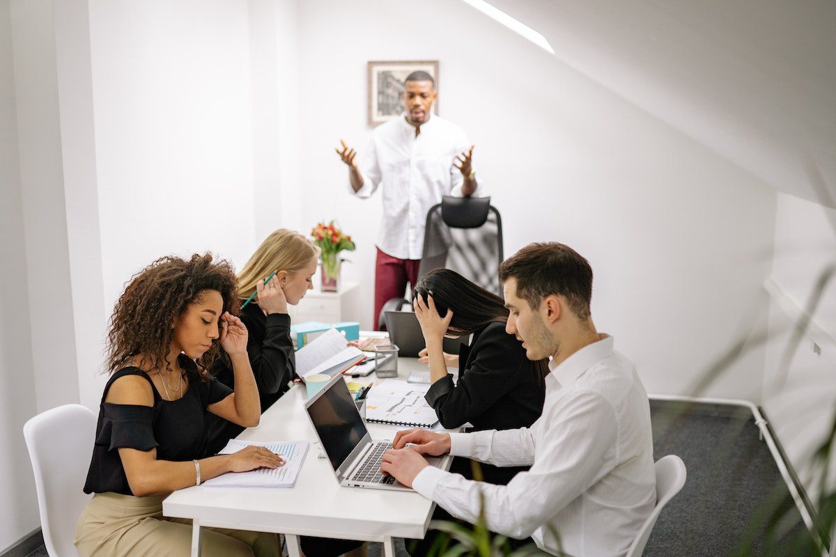 A man speaking to his team members during a meeting