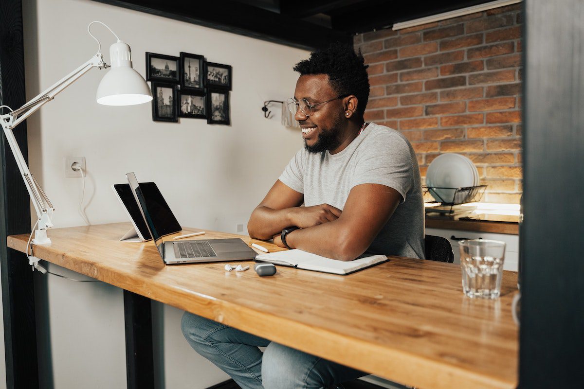 A man taking a free coding bootcamp online from his kitchen