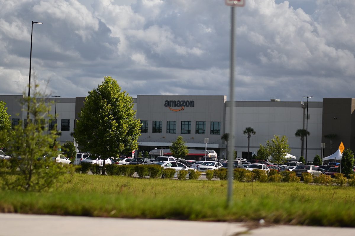 An Amazon building under a cloudy sky
